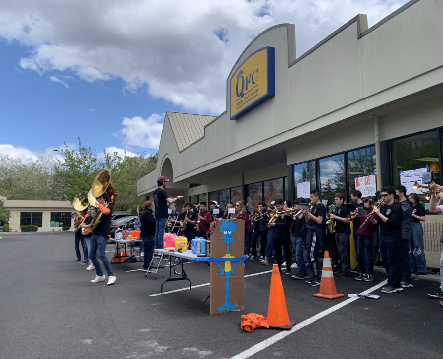 The MIHS Marching Band performs outside QFC to raise money for MIYFS.