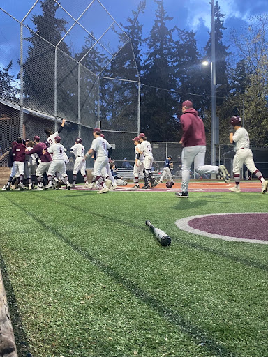 MIHS Baseball players mob home base after junior Marques Abulhosn steals home.