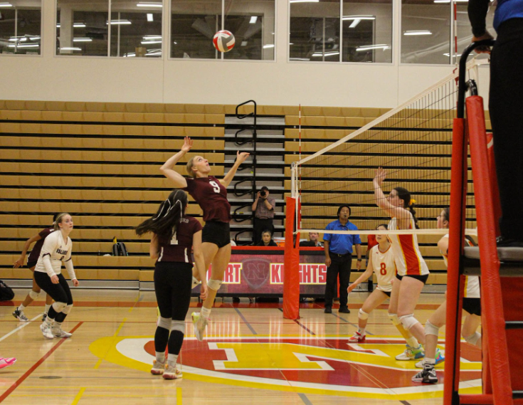 Senior Addison MacKay in flight to spike the ball against Newport.